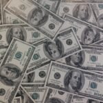 Stack of U.S. hundred dollar bills representing interest rates and personal finance