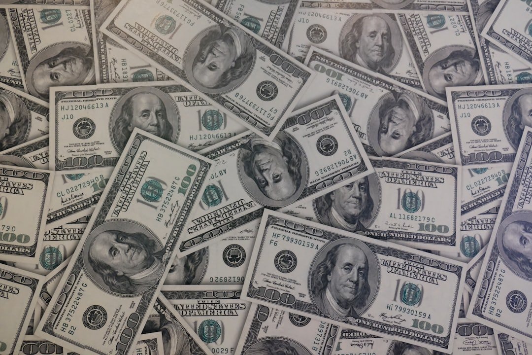 Stack of U.S. hundred dollar bills representing interest rates and personal finance