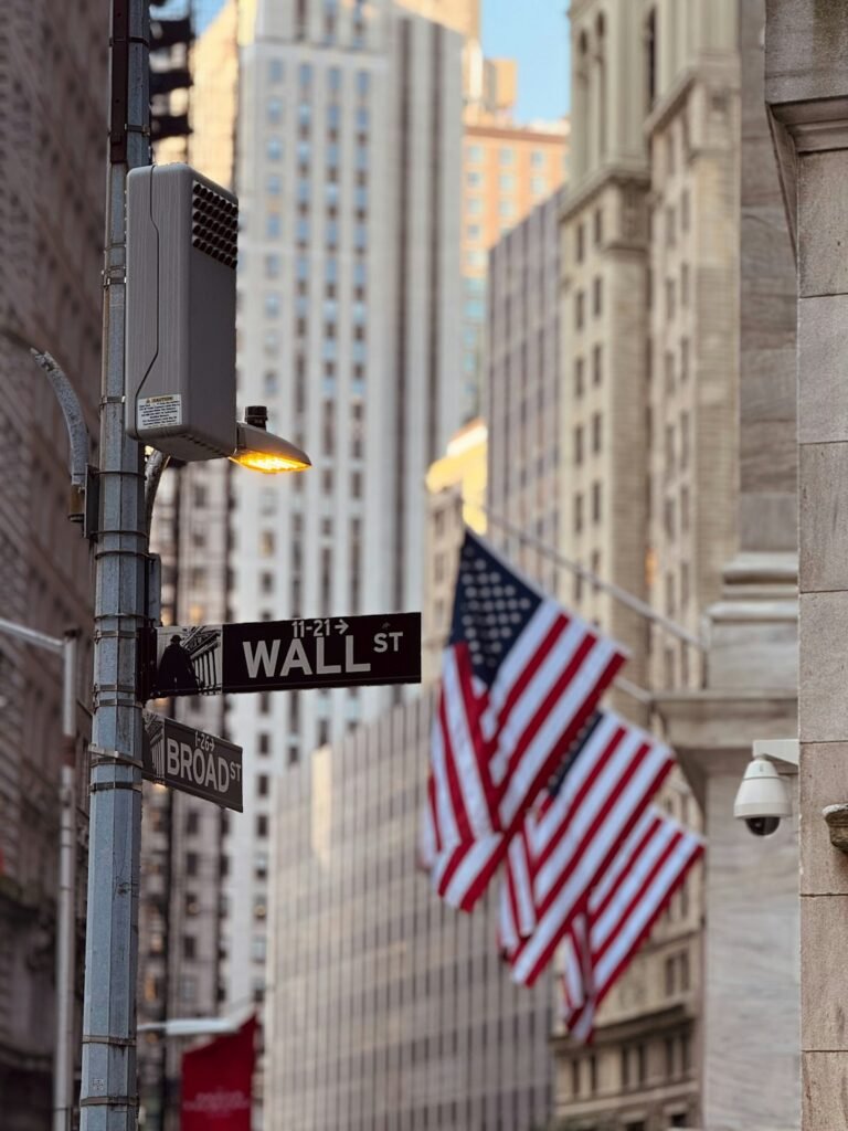 Wall Street street sign with American flags in the background